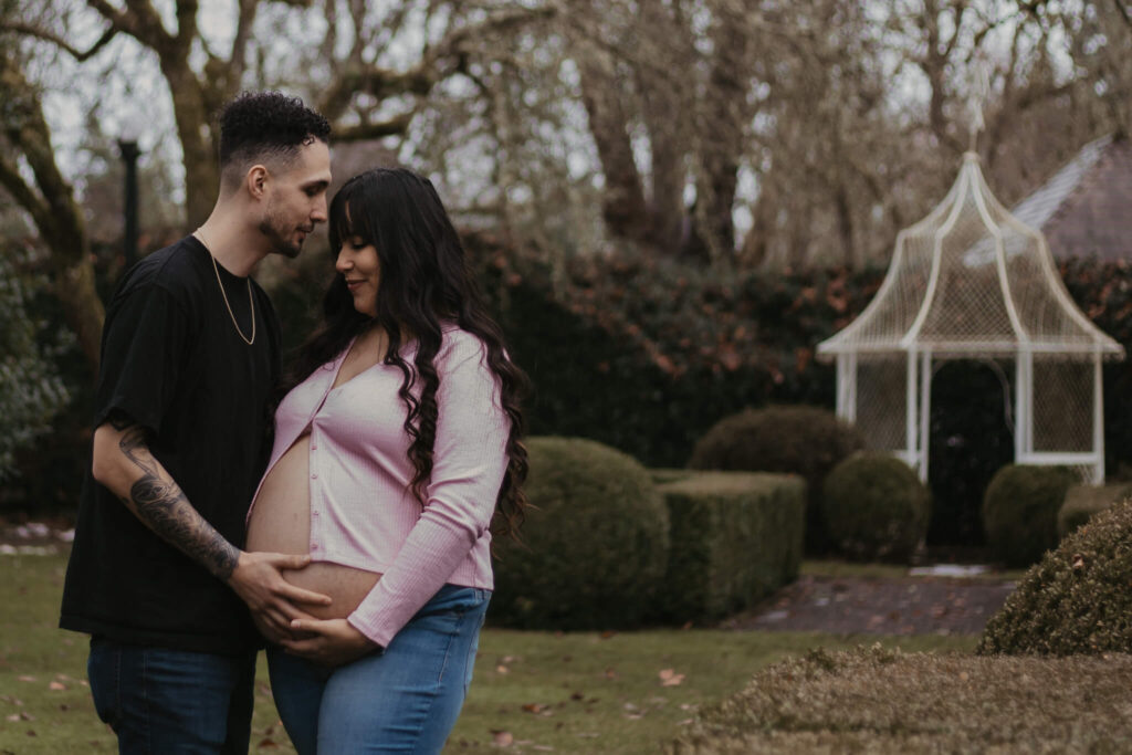 Couple standing in front of gazebo during their maternity photos at Deepwood Museum & Gardens.