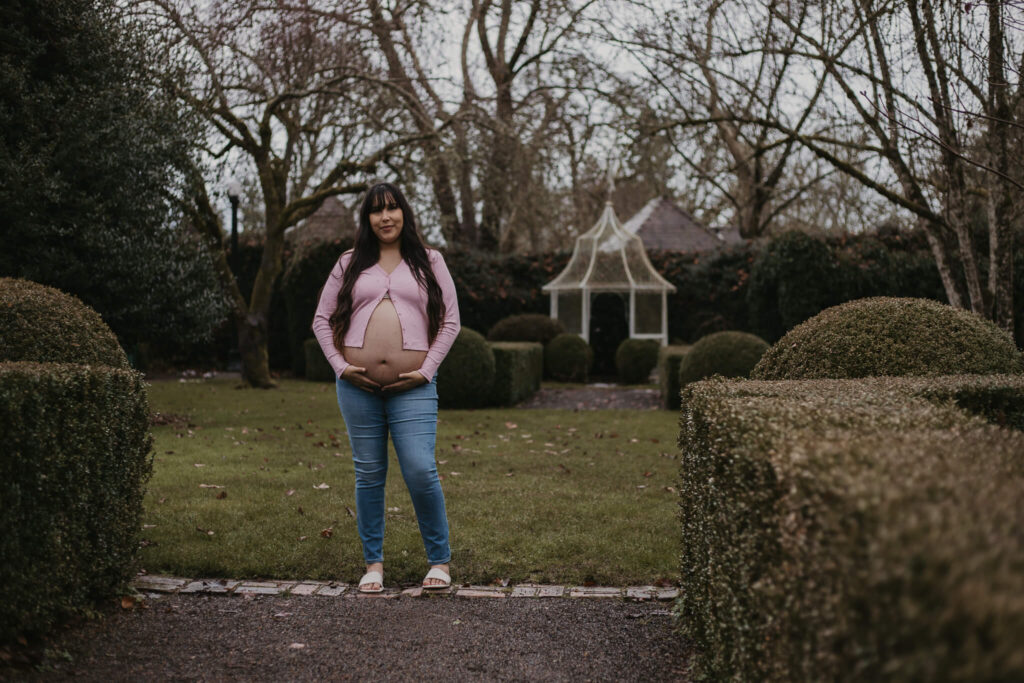 Expecting mother in front of gazebo during maternity session.