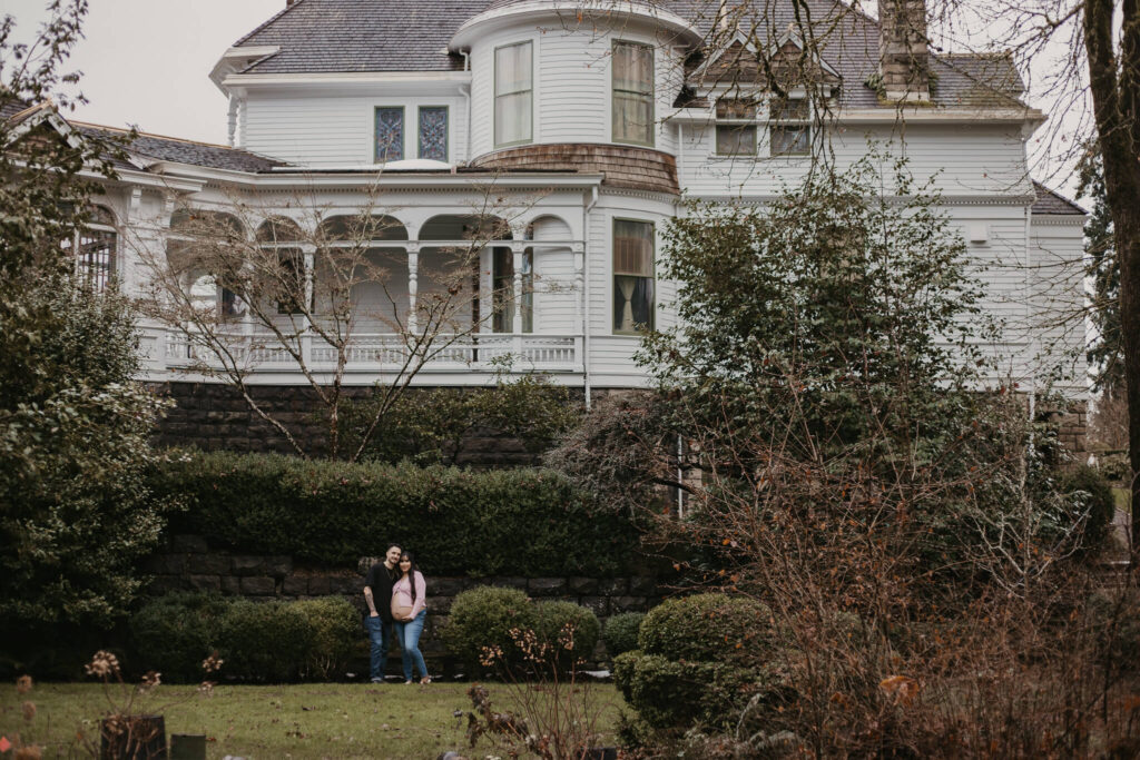 Expecting parents posing for their maternity session at Deepwood Museum & Gardens.